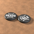 Black umpire flip coin with white lettering